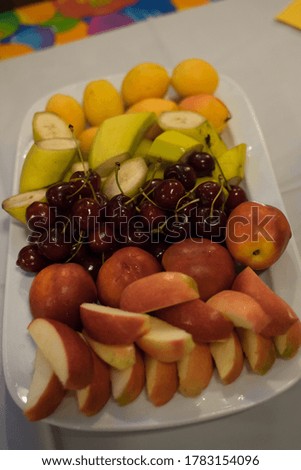 fruits lie on a white plate on the table
