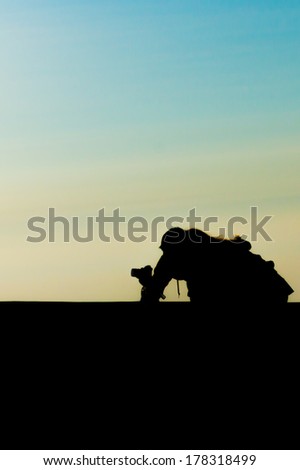 Silhouette of photographer  in blue sky