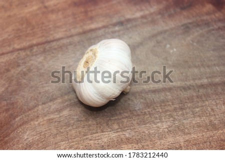 Bulb of Garlic or Knob of Garlic or Head of Garlic with Cloves on a Wooden Cut Board, Selective Focus 