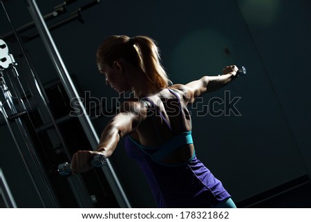 Image of fitness girl in gym exercising with dumbbells