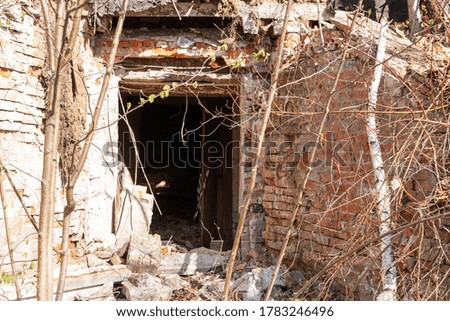 Facade of an abandoned building. Ruins of a small abandoned town