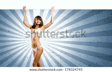 Young pretty girl in bikini holding blank banner