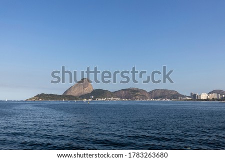 Sugarloaf mountain in Rio de Janeiro, Brazil, seen from the Guanabara bay against a clear blue sky