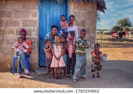 Family life group of African kids and mother in a village in Botswana Royalty-Free Stock Photo #1783294862