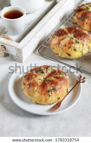 Korean garlic cheese bread on white plate plate and on cooling rack. Selective focus and not in focus
