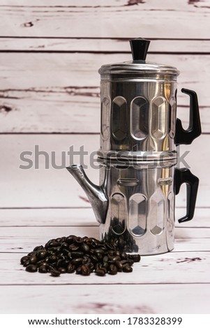 Neapolitan traditional coffee pot on a vintage style wooden background. Delicious fresh coffee. Royalty-Free Stock Photo #1783328399