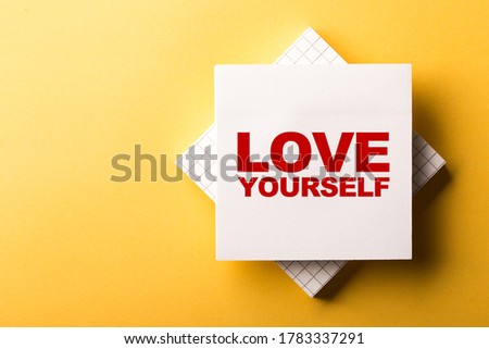 Love Yourself concept sticky note on yellow background.