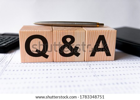 Close-up Shot of Q and A wooden blocks. Financial, marketing and business concepts