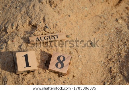August 18, Number cube with Sand background.	