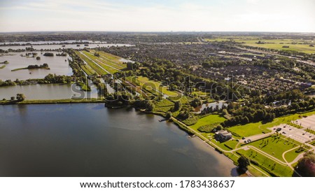 Aerial drone image of a beautiful lake with a small bikepaths in between.