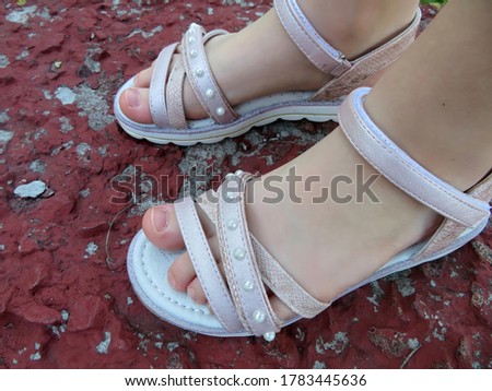 Children's feet in light sandals                               