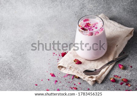 Pink Moon Milk for a better sleep, midnight relaxing drink, roses, grey background  Royalty-Free Stock Photo #1783456325