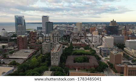 Aerial view of the Milwaukee skyline from the north side of the city, Michigan lake shoreline. Cloudy morning, summertime. 