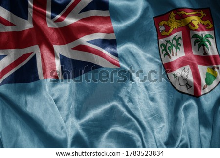 waving colorful shining big national flag of Fiji on a silky texture