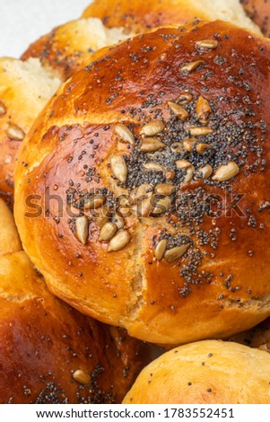 Close-up of homemade plain yeast dough with round yeast dough on a platter, blue poppy and sunflower seeds