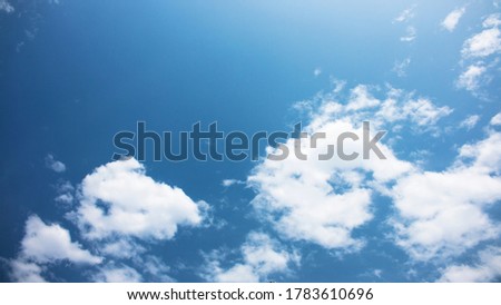 A blue sky with white clouds. A useful background for sky replacement in photos. Perfect material for editing and photo enhancing.