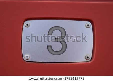 Number three on a red background
