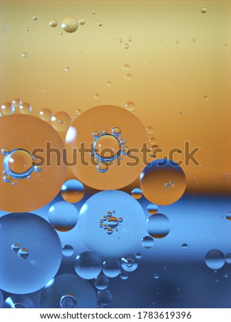  Abstract bubbles oil on yellow- blue background and shiny ,macro image, bright wallpaper ,droplets background
