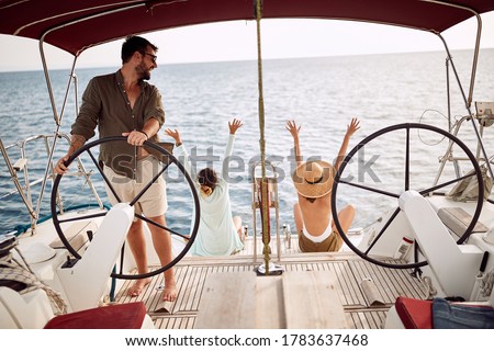 Friends excited by the trip with a yacht ona wonderful sunny day Royalty-Free Stock Photo #1783637468