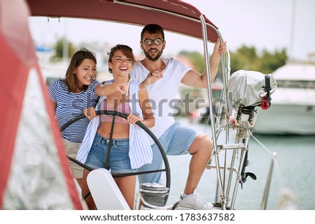 Friends enjoy riding a yacht on a sunny day