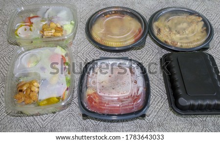 To go container with food ordered online for curbside pick-up due to cobid-19.