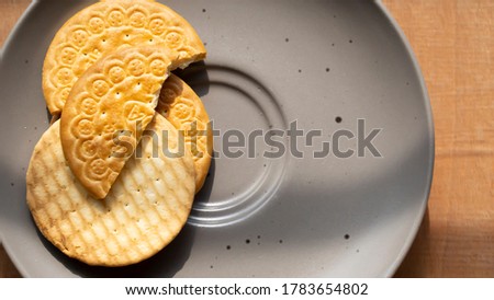 Indian tea time biscuits are kept on nice gray plate with beautiful morning light shadow 