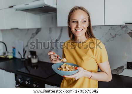 Attractive Young Woman Eating Breakfast From Glass Bowl