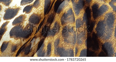 Pareo with leopard print in folds (texture).
