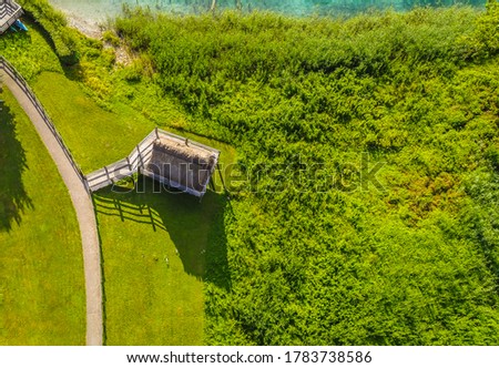 Ledro lake, Italy. Reconstructed huts on stilts to show the life during the prehistoric time. View of the lake and archeological area. An Unesco world heritage site