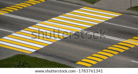Bright colored road markings on the street with a crossing.