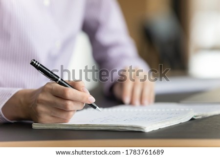 Close up crop view of woman handwrite in notebook study online at home, smart concentrated female write in exercise book, summarize important data, prepare for exam session, take educational course Royalty-Free Stock Photo #1783761689