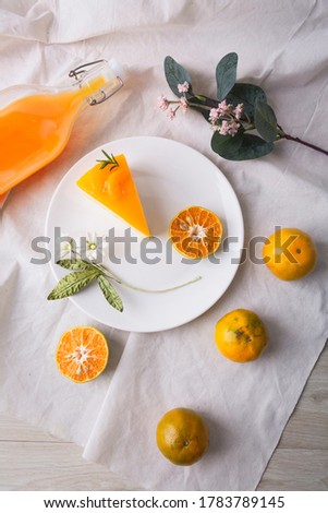 Orange sherbet layer cake top with slice orange and orange juice