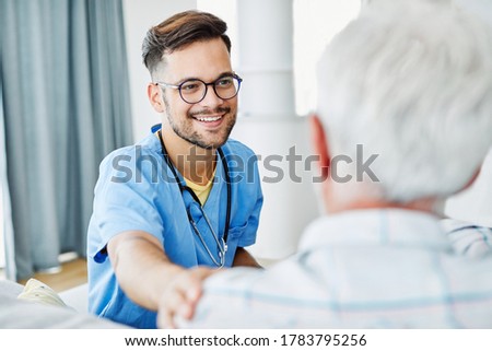 Doctor or male caregiver with senior man holding a cane on sofa at home or nursing home Royalty-Free Stock Photo #1783795256
