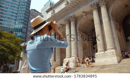 Young tourist taking a photo in New York City