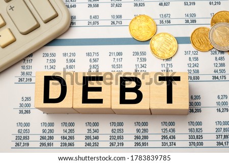 Wooden blocks with the word Debt. Reduction or restructuring of debt. Refusal to pay debts or loans and invalidate them Royalty-Free Stock Photo #1783839785