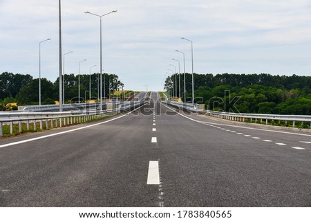 New asphalt highway in summer on a background of blue sky