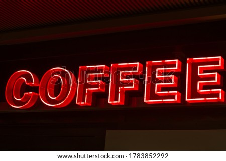 Neon light and LED promotion in bright red tone presented "Coffee Word" for cafe and restaurant advertisement, business promotion. Present in low key and high contrast for attractive.