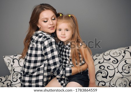 Happy loving family. Mother and her girl play, kiss and hug.
