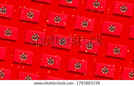 Repeated pattern of christmas presents. Golden decorative bow top horizontal view copyspace. New year 2021 and christmas  concept