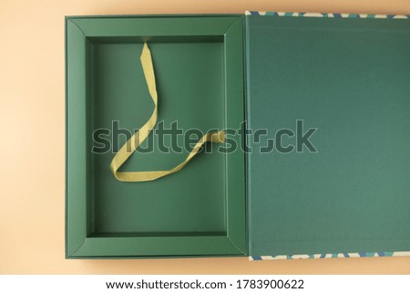Ecological green gift box on yellow background. Empty box