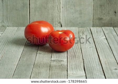 tomatoes on old, weathered wooden background