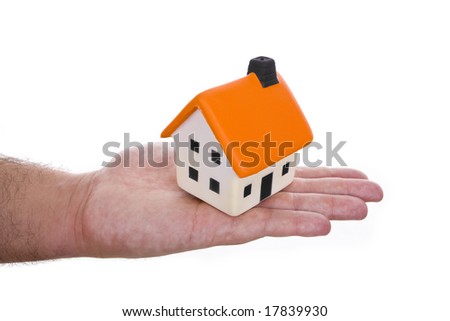 hand holding small house - real state concept