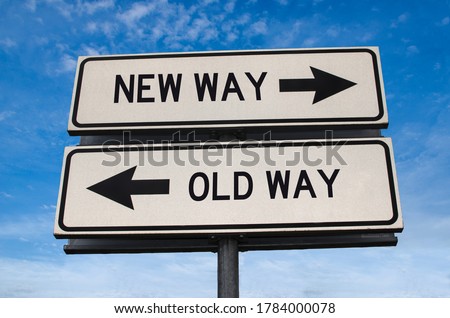 New way versus old way road sign. White two street signs with arrow on metal pole with word. Directional road. Crossroads Road Sign, Two Arrow. Blue sky background. Two way road sign with text. Royalty-Free Stock Photo #1784000078