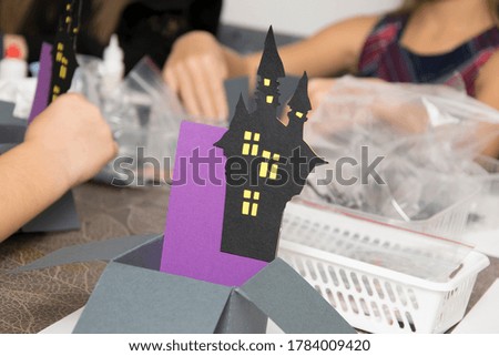 
Children make a holiday craft box for Halloween.