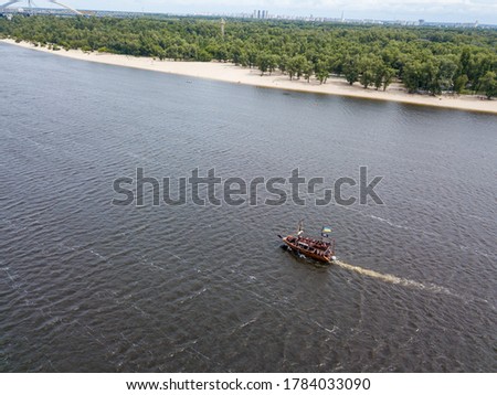Aerial drone view. A pirate motor boat sails along the Dnieper River in Kiev.