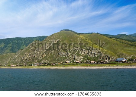 small village on a emerald river coast, rural landscapr