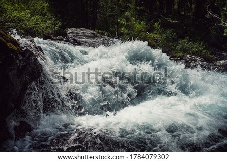 Big rapids of powerful mountain river. Beautiful background with azure water in fast river. Frozen motion of tall mountain river rapids. Power majestic nature of highlands. Backdrop of aqua turbulence Royalty-Free Stock Photo #1784079302