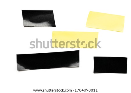 Adhesive sticky paper. Piece of yellow and black duct scotch tape isolated on white background. Torn strip grunge texture