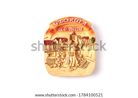 Georgia old tbilisi souvenir. Souvenir with depiction of medieval georgian people. Isolated on white background. Royalty-Free Stock Photo #1784100521