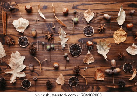 Hello autumn. Pattern made of dried leaves, acorns and pine cones. Seasonal background, fall concept, thanksgiving day composition. Flat lay, top view